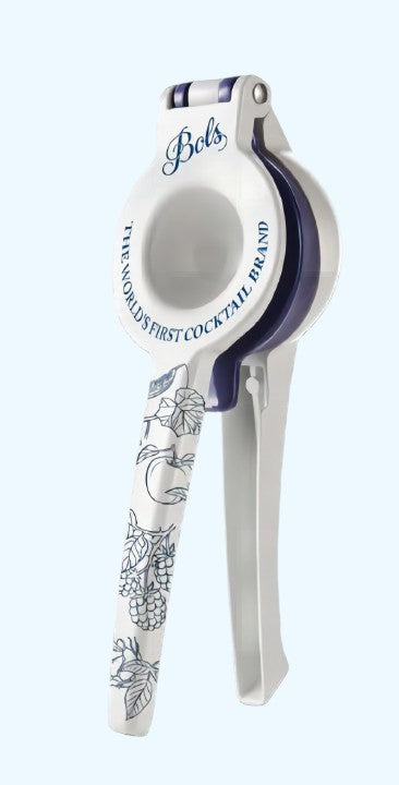 A white and navy blue metal lime squeezerr with 'Bols' branding and floral illustrations on the handle, set against a light blue background.
