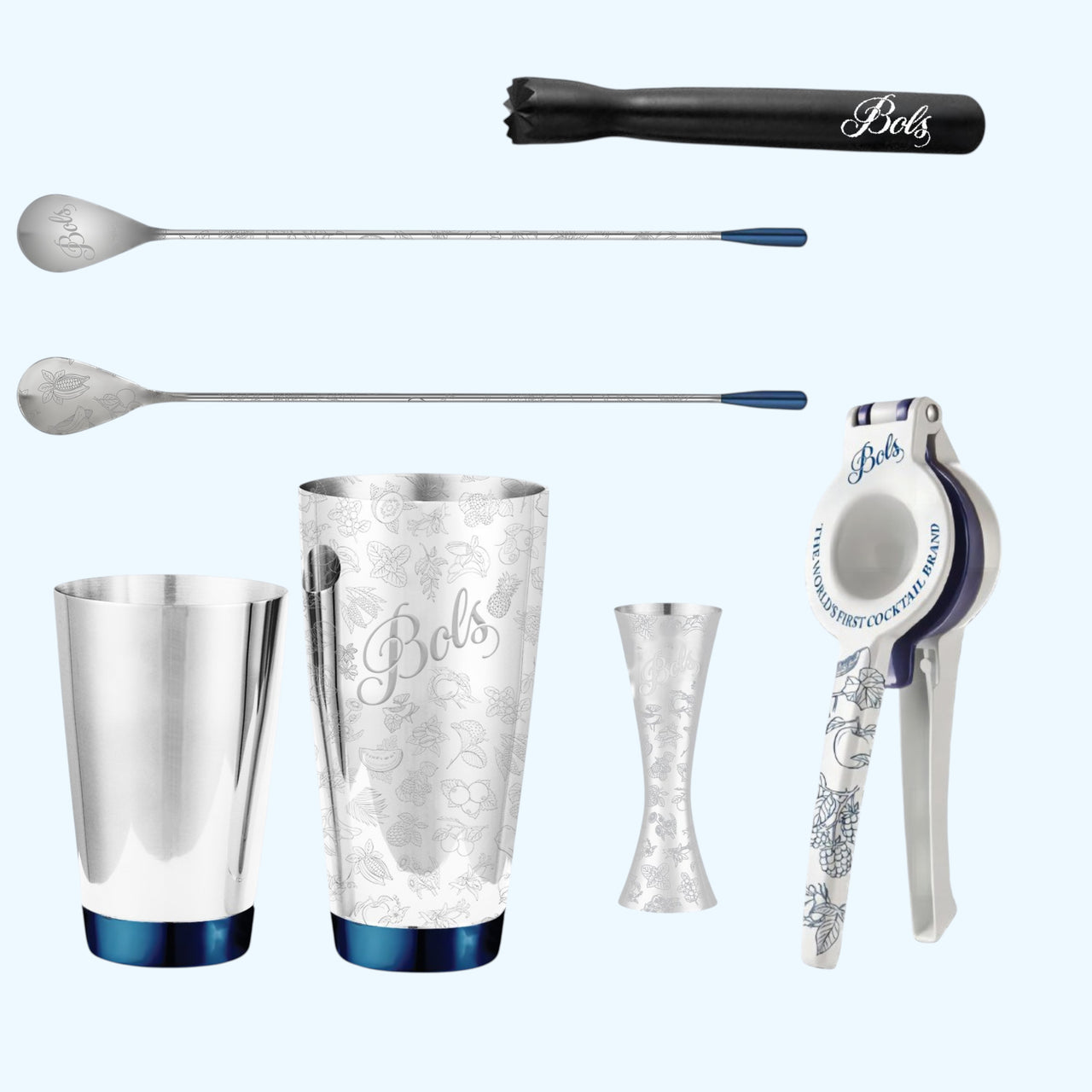 A Bols cocktail and mixing tool set arranged on a light blue background, including a black muddler, two metal spoons with blue handles, a silver shaker tin, a jigger, a strainer, and a citrus press.