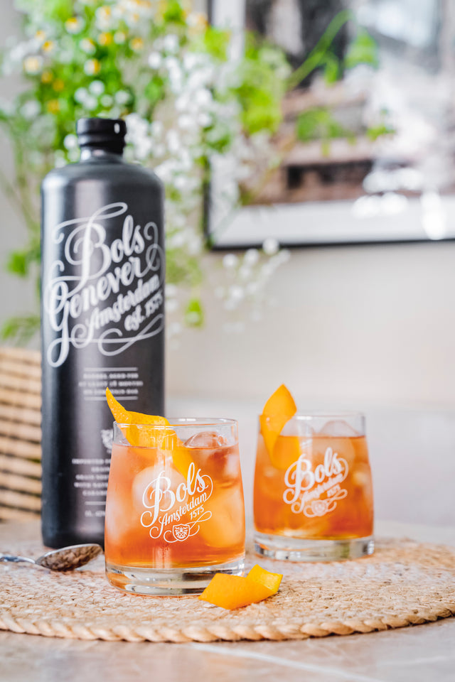 Bottle of barrel aged genever with 2 glasses of very old fashioned cocktail 